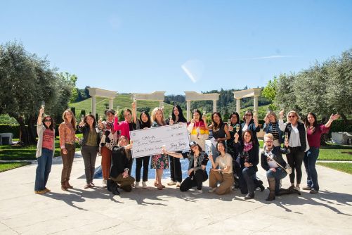 Women Raise a Toast While Presenting Donation Check